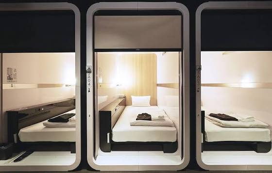 A corridor of cabins closed with fabric panels rather than doors.